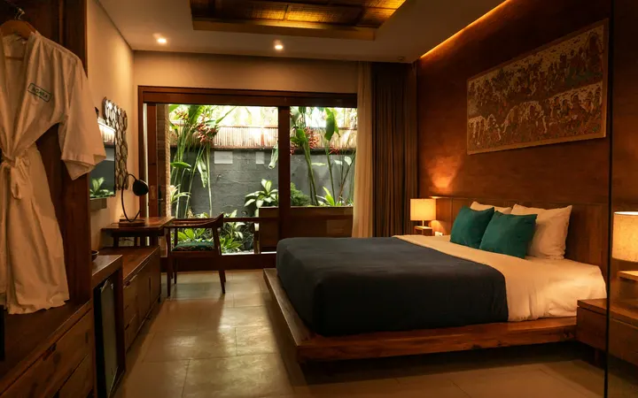 Hotel bedroom with a wooden bed and a garden view