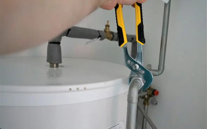 Plumber working on a home water heater